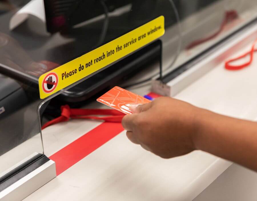 Presenting METRO Q Fare Card through a clerk window.